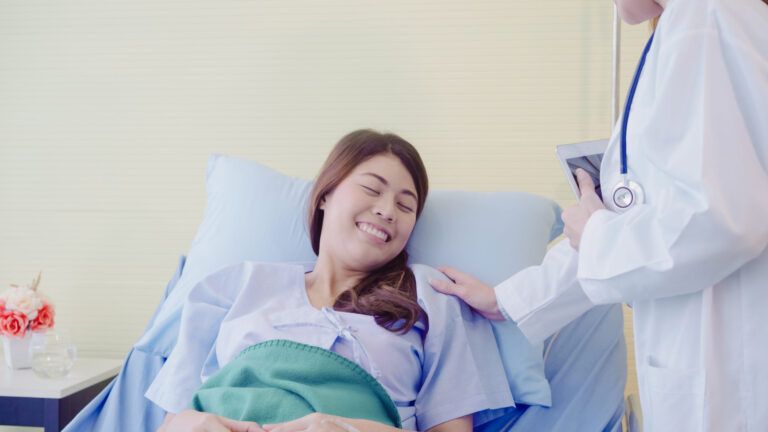 young asian doctor woman talking and holding hand for women patient in sick bed scaled 1