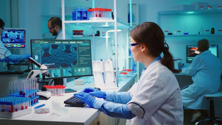 overworked chemist sitting in modern equipped lab looking tired at camera scaled 1